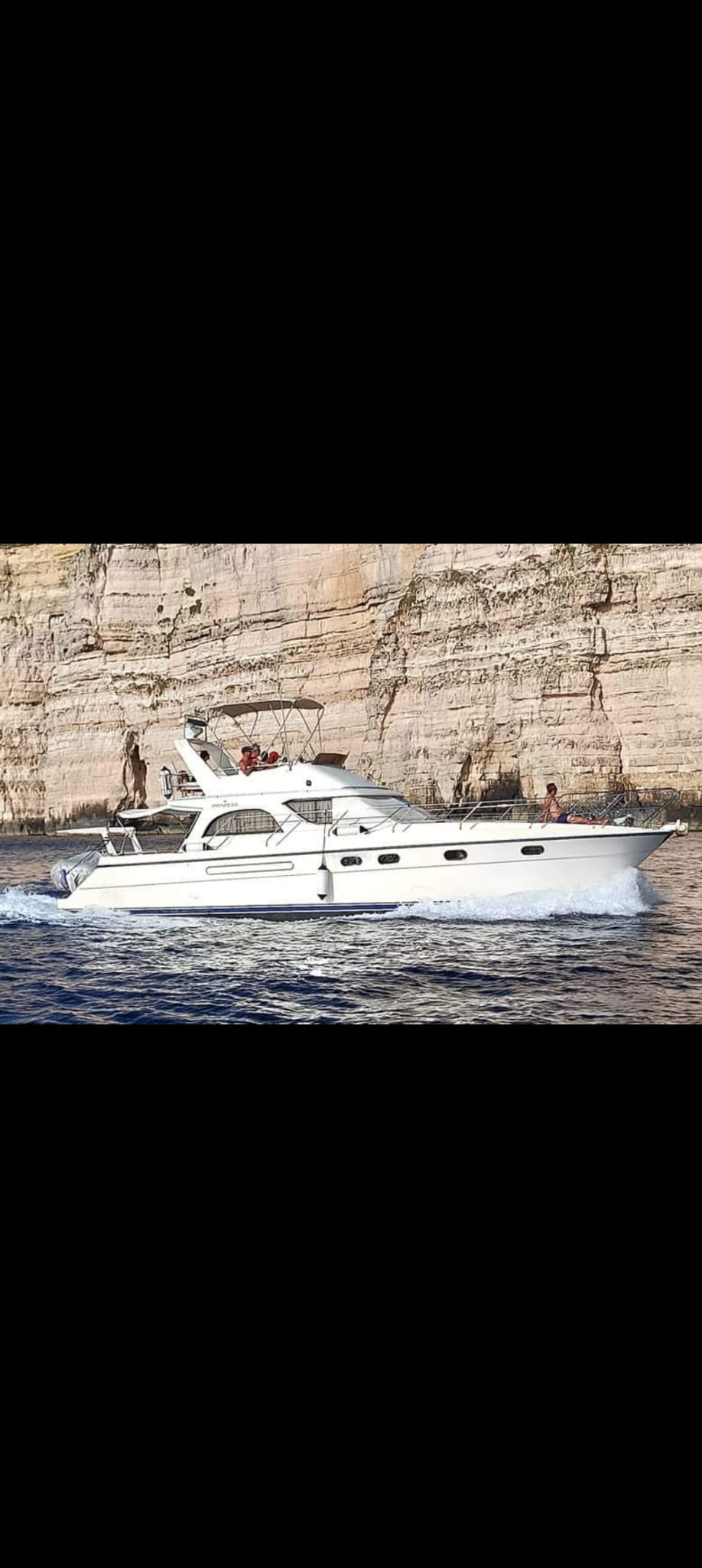Zeppi Boat cruising past Malta's dramatic coastal cliffs
